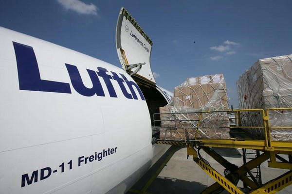 Lufthansa cargo airplane being loaded with packages.