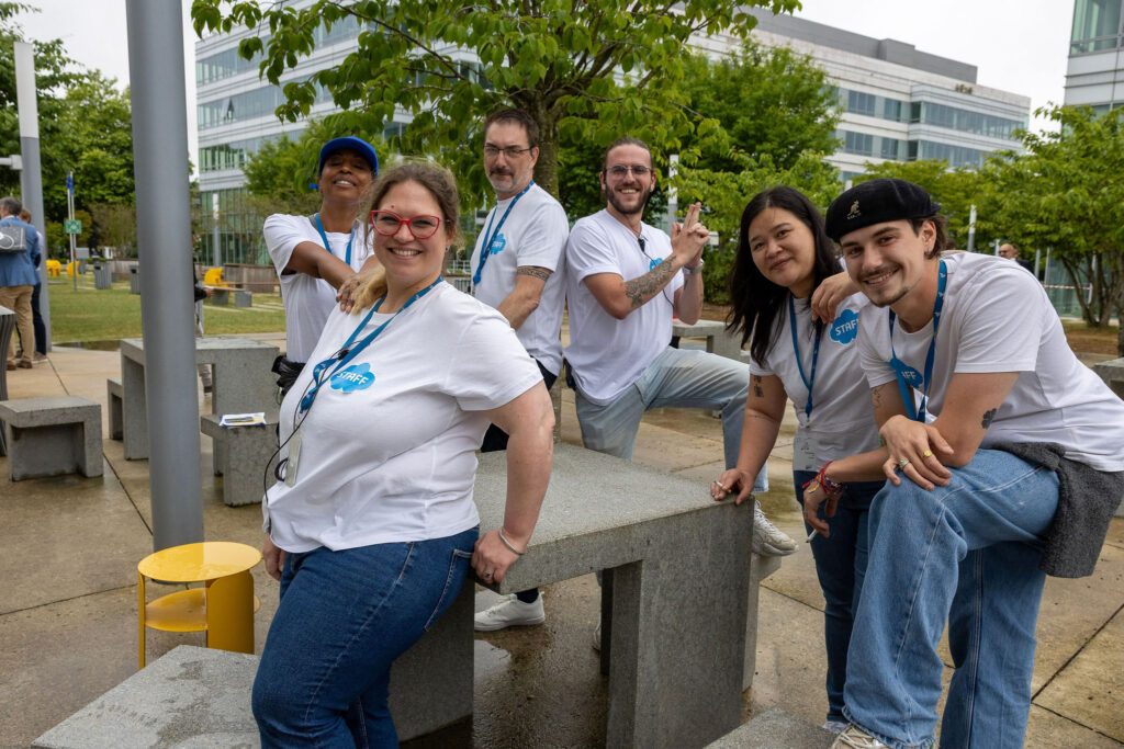 A smiling group of staff from Dassault Systemes' KIDS' DAY at the Paris Campus get ready for the day's activities. 