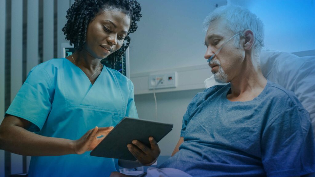 A medical provider looks at a digital tablet with a patient - CES 2026 - Dassault Systemes blog