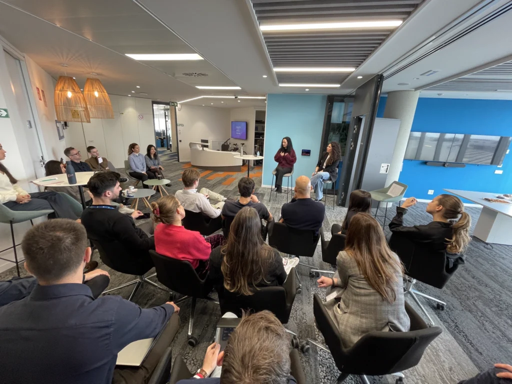 Two women speakers talking to a group of employees at Dassault Systemes for International Women's Day. 