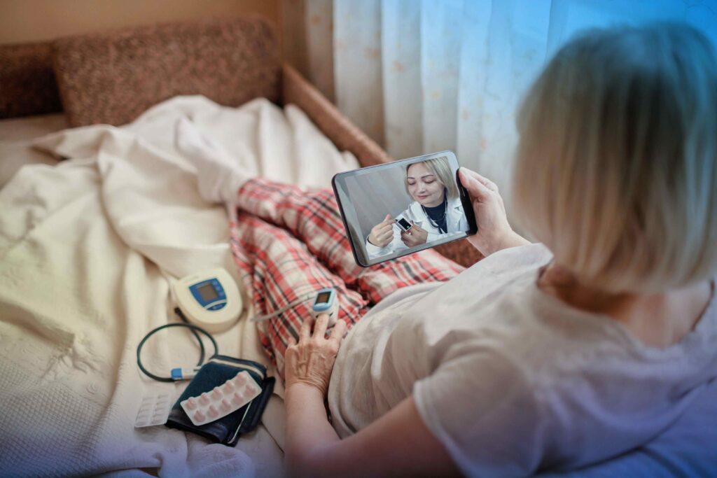 A patient attends a telehealth appointment while wearing a pulse oximeter - gender health equity gap - Dassault Systemes blog 